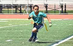 Young boy playing flag football.